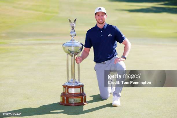 Daniel Berger of the United States celebrates with the Leonard Trophy after defeating Collin Morikawa of the United States in a playoff during the...