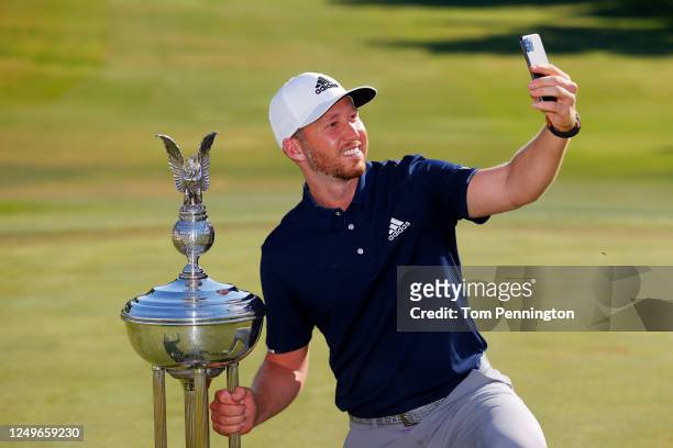 Daniel Berger of the United States takes a selfie as he celebrates with the Leonard Trophy after defeating Collin Morikawa of the United States in a...