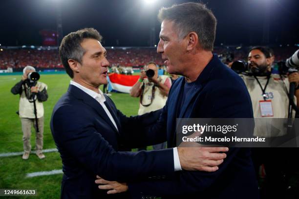 Managers Guillermo Barros Schelotto of Paraguay and Eduardo Berizzo of Chile embrace before an international friendly match at Estadio Monumental...