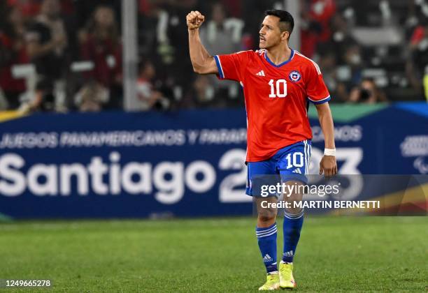 Chile's forward Alexis Sanchez celebrates an own goal scored by Paraguay's goalkeeper Antony Silva during the friendly football match between Chile...