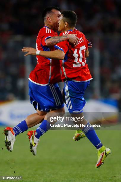 Alexis Sanchez of Chile celebrates with teammate Gary Medel after scoring the second goal of his team during an international friendly match against...