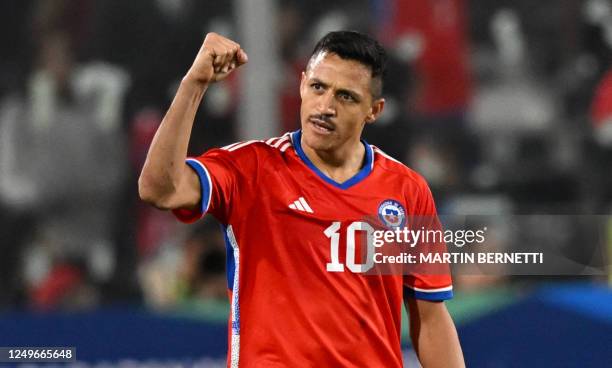 Chile's forward Alexis Sanchez celebrates an own goal scored by Paraguay's goalkeeper Antony Silva during the friendly football match between Chile...