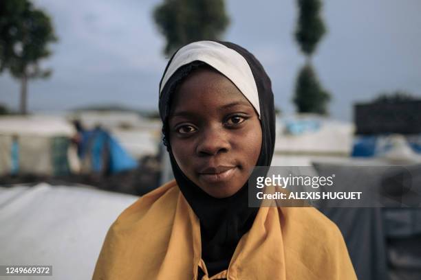 Displaced Muslim girl who fled attacks by the M23 rebels poses for a photograph at an informal displacement camp in Goma, eastern Democratic Republic...