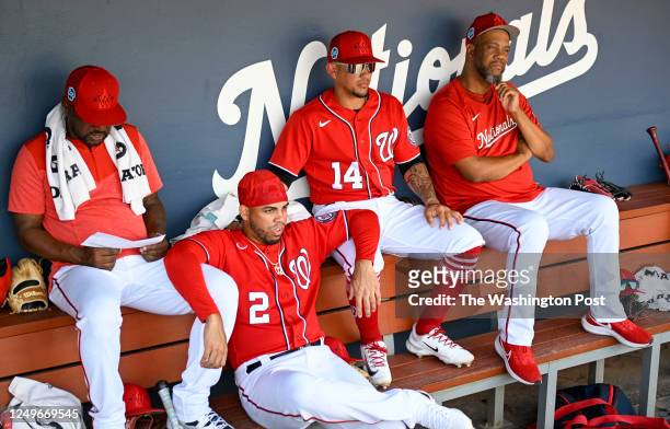 Washington Nationals second baseman Luis Garcia sits with coach Ricky Gutierrez infielder Ildemaro Vargas and guest instructor Livan Hernandez during...