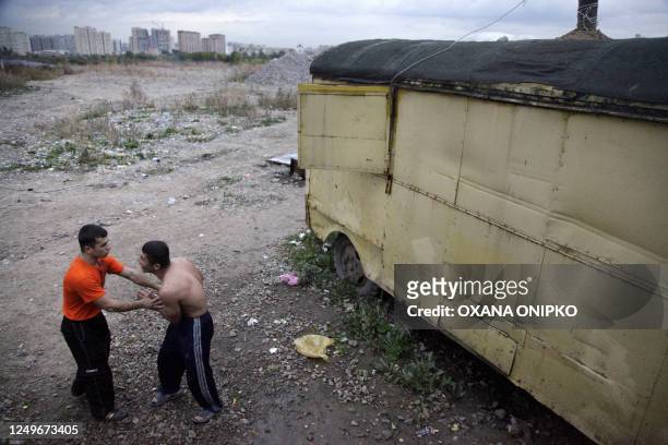 Akbar BORISOV Tajik migrant workers relax after a day of work in Moscow on September 23, 2009. Stuck working abroad for years at a stretch to escape...
