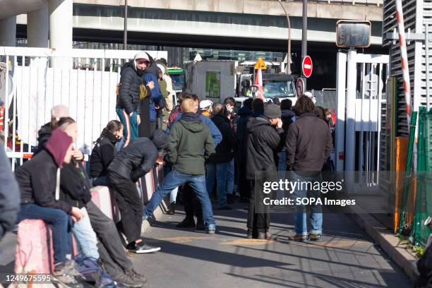 People are seen blocking the Ivry-sur-Seine waste incinerator centre. Garbage collectors, trade unionists, students, and railway workers blocked the...