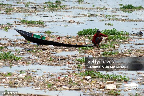 Scavenger collects plastics in the Citarum river in Bandung, West Java on March 28, 2023.