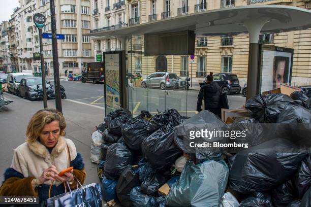 Uncollected bags of trash piled up by a bus stop during a strike by sanitation workers, in central Paris, France, on Tuesday, March 28, 2023. French...