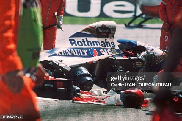 Security surrounds the crashed car of Ayrton Senna at the Imola track 01 May 1994. The triple Formula One champion died after crashing in the seventh...