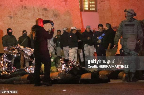 Firefighters and Mexican soldiers rescue migrants from an immigration station in Ciudad Juarez, Chihuahua state on March 27 where at least 39 people...