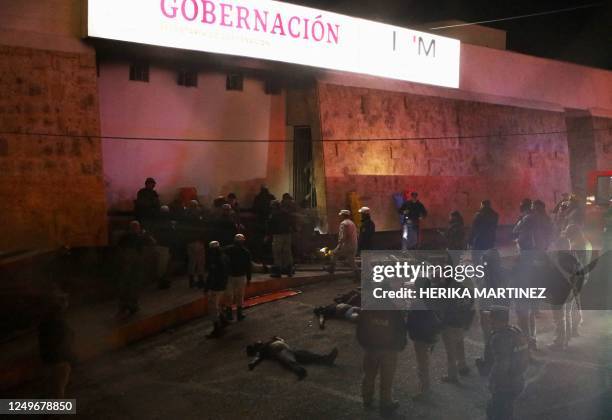 Firefighters and police rescue migrants from an immigration station in Ciudad Juarez, Chihuahua state on March 27 where at least 39 people were...