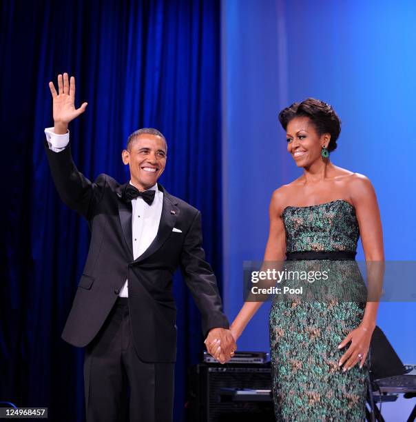 President Barack Obama and First Lady Michelle Obama wave during the Congressional Hispanic Caucus Institute's 34th Annual Awards Gala at the...