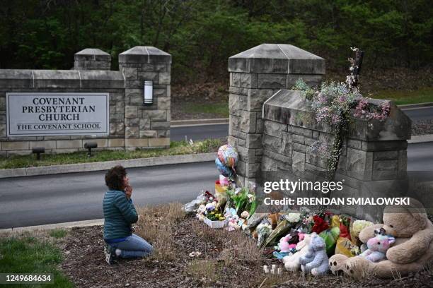 Robin Wolfenden prays at a makeshift memorial for victims outside the Covenant School building at the Covenant Presbyterian Church following a...