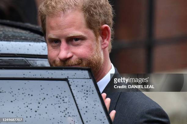 Britain's Prince Harry, Duke of Sussex gets in the car as he leaves the Royal Courts of Justice, Britain's High Court, in central London on March 28,...