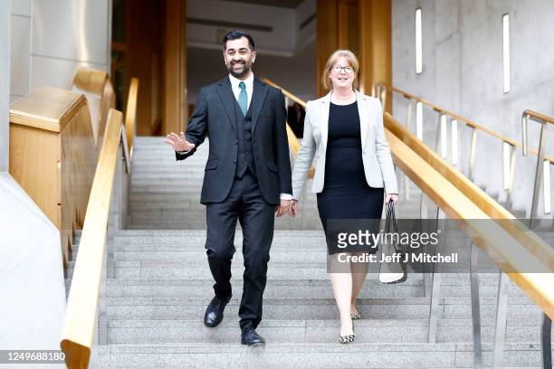 Newly elected leader of the Scottish National Party Humza Yousaf walks with MSP Shona Robison at the Scottish Parliament on March 28, 2023 in...