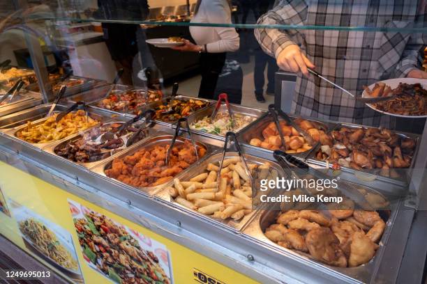 Eat as much as you like hot buffet at a Chinese restaurant in Chinatown on 27th March 2023 in London, United Kingdom. Many people eat bargain food...