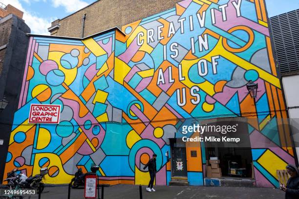 Large scale patterned mural outside the London Graphic Centre in Covent Garden reads 'Creativity Is In All Of Us' on 27th March 2023 in London,...