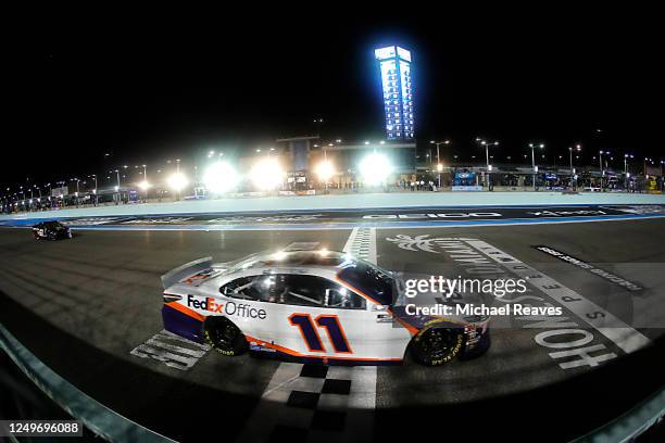 Denny Hamlin, driver of the Toyota, cross the finish line to win the NASCAR Cup Series Dixie Vodka 400 at Homestead-Miami Speedway on June 14, 2020...