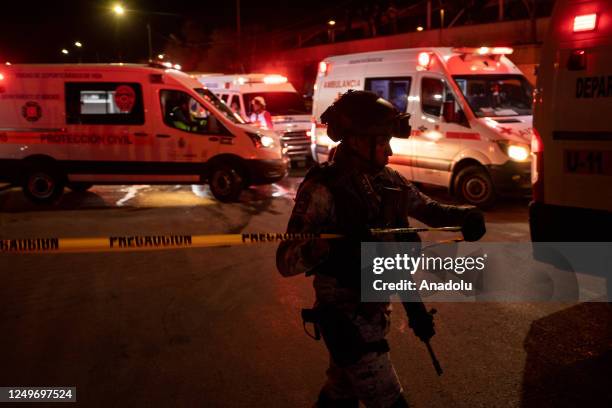 Personnel take measures at the scene after a fire broke out at a migration facility killing at least 39 migrants in the Mexican northern border city...