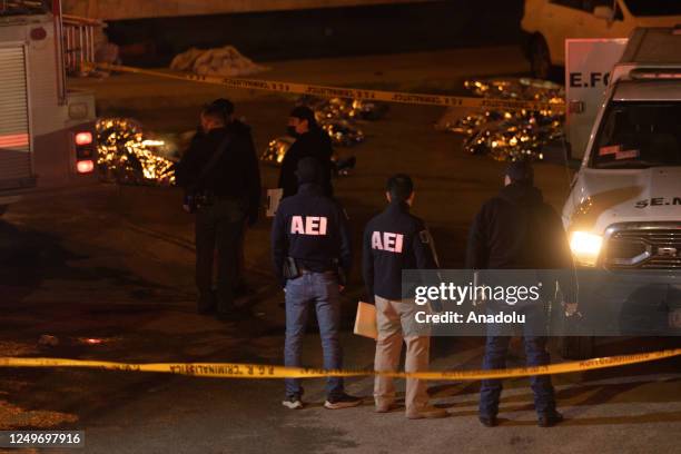 Personnel take measures at the scene after a fire broke out at a migration facility killing at least 39 migrants in the Mexican northern border city...