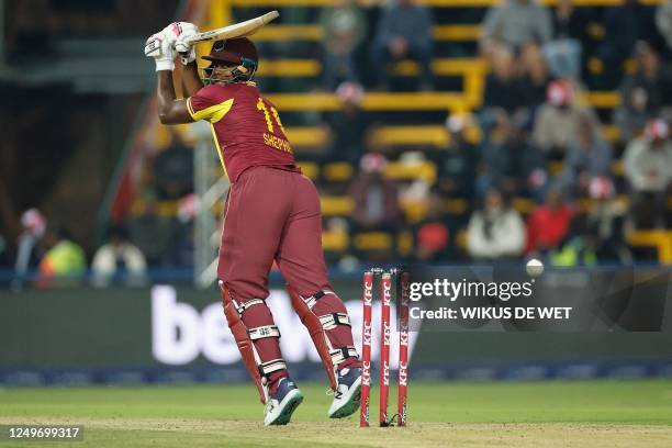 West Indies' Romario Shepherd watches the ball after playing a shot during the third T20 international cricket match between South Africa and West...