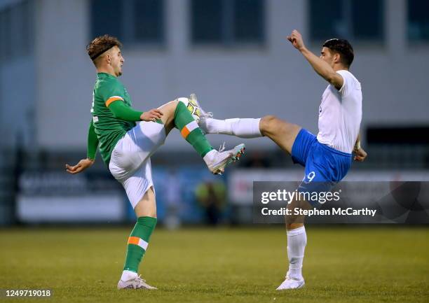 Wexford , Ireland - 28 March 2023; Sam Curtis of Republic of Ireland in action against Georgios Koutsias of Greece during the UEFA European Under-19...