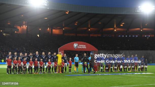 Both squads line up fpr their national anthem during a UEFA Euro 2024 Qualifier between Scotland and Spain at Hampden Park, on March 28 in Glasgow,...