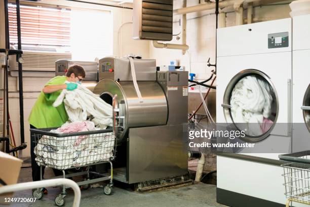 laundering sheets in a nursing facility - hospital cleaning stock pictures, royalty-free photos & images