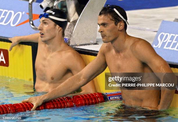 Russia's Alexander Popov and Netherlands' Pieter Van Den Hoogenband react following a men's 50m freestyle semi-final, 25 July 2003 in Barcelona, at...