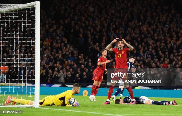 Spain's striker Joselu reacts as his header was saved by Scotland's goalkeeper Angus Gunn during the UEFA Euro 2024 group A qualification football...