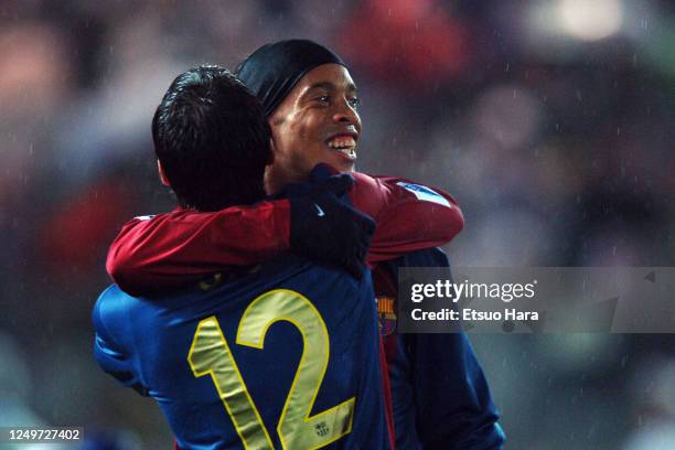 Ronaldinho of Barcelona celebrates scoring his side's third goal with his team mate Giovanni van Bronckhorst during the FIFA Club World Cup semi...