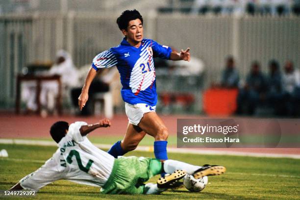 Yasutoshi Miura of Japan is tackled by Abdullah Al-Dosari of Saudi Arabia during the FIFA World Cup Asian Qualifier final round match between Saudi...