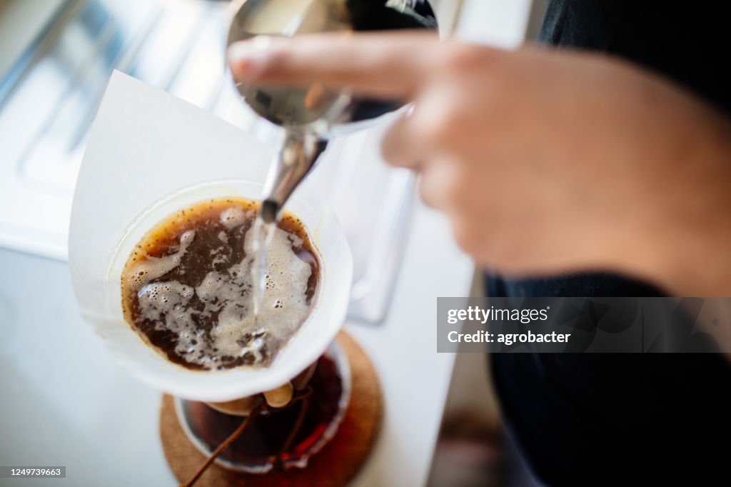 Teenage brewing coffee at home