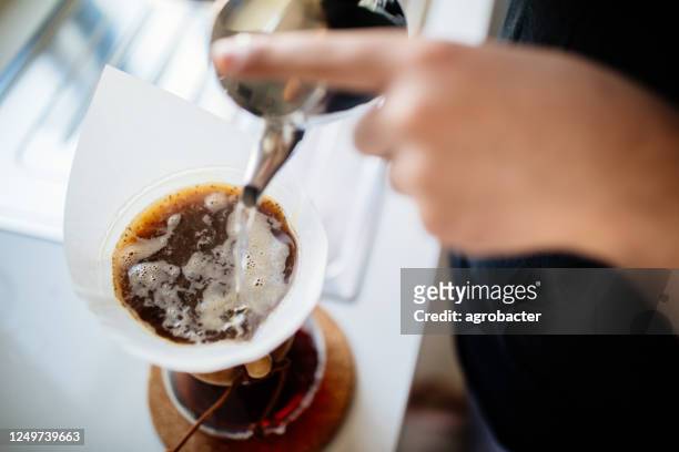teenage brewing coffee at home - pouring stock pictures, royalty-free photos & images
