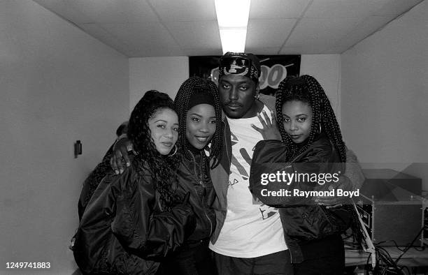 Singers Tonya Kelly, Di Reed and Joi Marshall of Jade poses for photos with rapper Big Daddy Kane backstage at the Marcus Amphitheatre in Milwaukee,...