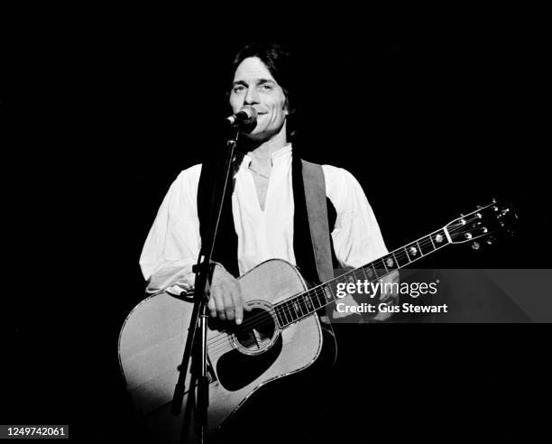 Gene Clark of McGuinn, Clark & Hillman performs on stage at the Hammersmith Odeon, London, England, on April 30, 1977.