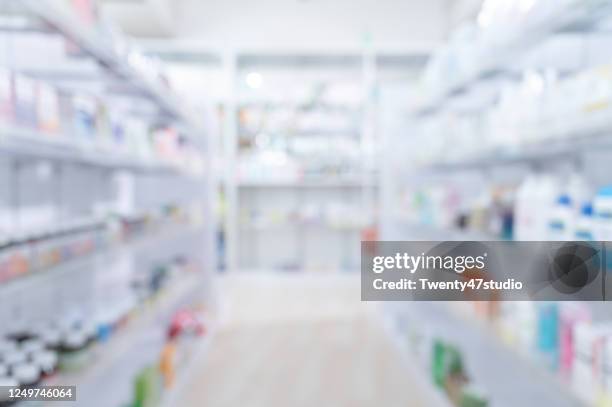 pharmacy medicine shelf in a row blurred background - pharmacy imagens e fotografias de stock