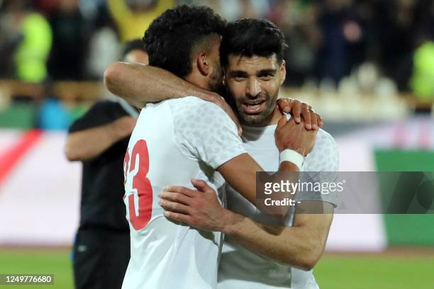 Iran's defender Ramin Rezaeian celebrates with Mahdi Taremi after scoring his team's second goal during the friendly football match between Iran and...