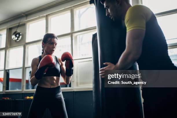 woman on kick box practice with coach - boxing trainer stock pictures, royalty-free photos & images