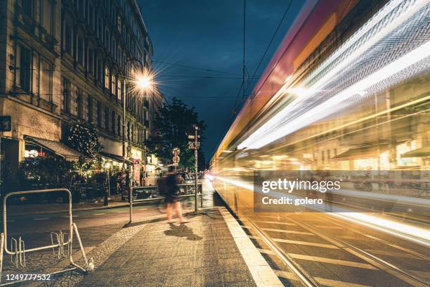 yellow tram passing metro station in prenzlauer berg at night,  berlin - prenzlauer berg imagens e fotografias de stock