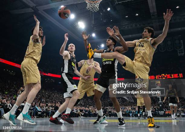Alen Smailagic and Zach LeDay of Partizan competes for the ball against Alex Abrines and Nicolas Laprovittola of Barcelona during the 2022-23 Turkish...