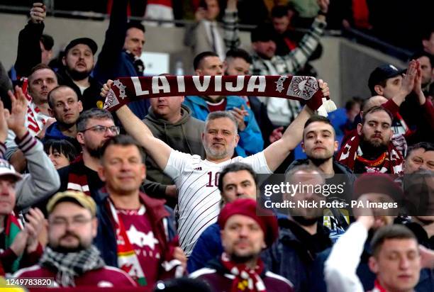 Latvia fan holds up their scarf at the end of the UEFA Euro 2024 qualifying group D match at the Cardiff City Stadium, Cardiff. Picture date: Tuesday...