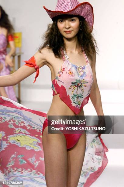 Japanese model displays a bikini swimsuit with a wrapped skirt during the 2000 swimwears collection at a Tokyo department store as part of the sales...