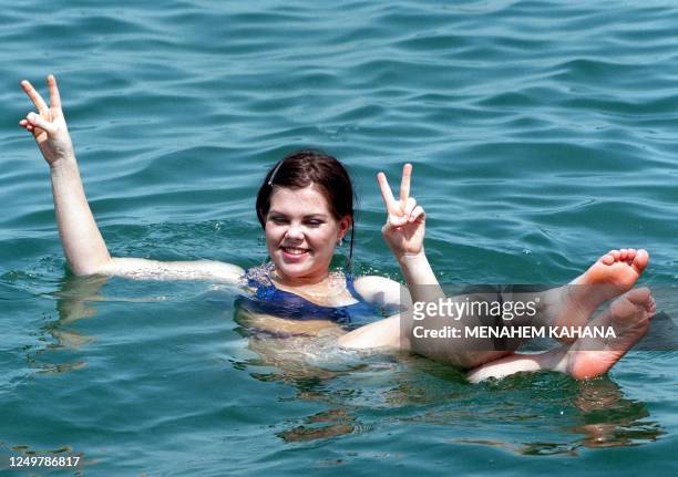 Bobbie Singer, Austria's entry in the Eurovision song contest flashes V-signs as she dips in the Dead Sea in Ein Boqek 26 May 1999. The Eurovision...