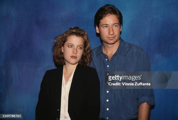 American-British actress Gillian Anderson, wearing a black trouser suit with a white blouse, and America actor David Duchovny, wearing a blue shirt,...