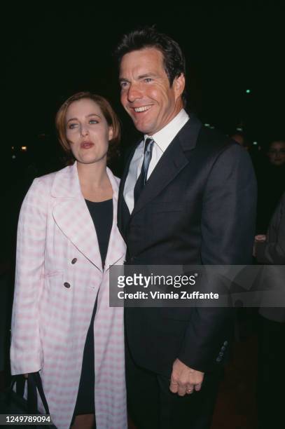 American-British actress Gillian Anderson and American actor Dennis Quaid attend the premiere of 'Playing by Heart', held at the Academy Theatre in...