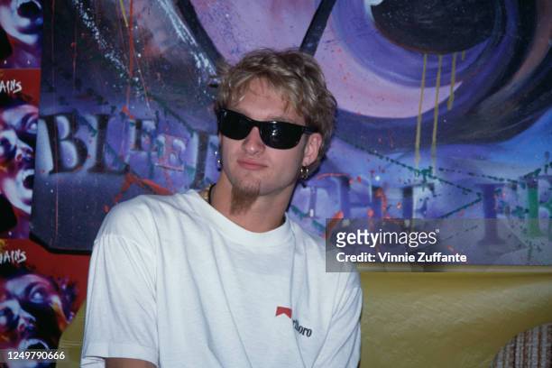 American singer and musician Layne Staley , lead singer of the rock band Alice in Chains, wearing sunglasses and a white t-shirt with the Marlboro...