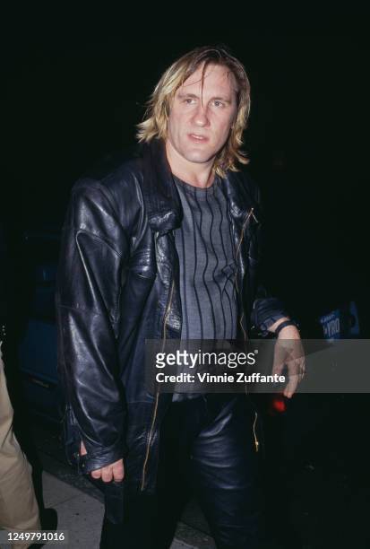 French actor Gerard Depardieu wearing a grey sweater with black stripes, beneath a black leather jacket, circa 1985.