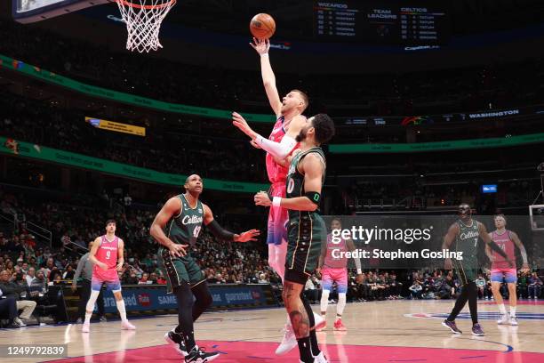 Kristaps Porzingis of the Washington Wizards drives to the basket during the game against the Boston Celtics on March 28, 2023 at Capital One Arena...