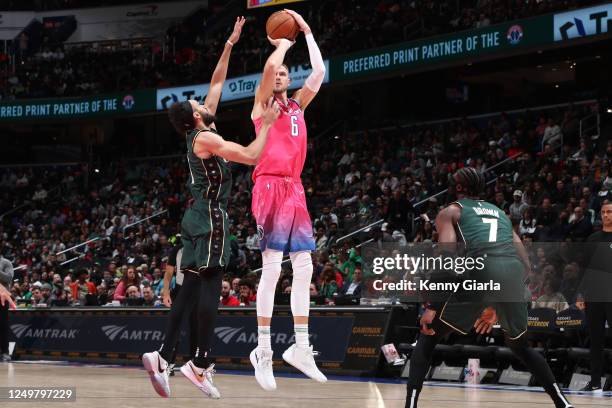 Kristaps Porzingis of the Washington Wizards shoots the ball during the game against the Boston Celtics on March 28, 2023 at Capital One Arena in...